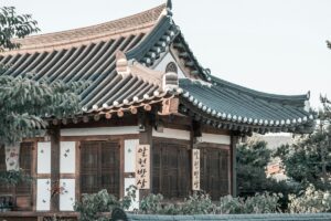 2025 Chichijik Marketing Guide for Korea: A traditional Korean house with its distinctive tiled roof and wooden - framed structure stands amidst greenery. The building is adorned with Korean calligraphy on wooden plaques and charming butterfly - like decorations. This image of cultural heritage can inspire unique marketing approaches on Chichijik, helping brands connect with the deep - rooted traditions and aesthetics appreciated by the Korean audience.