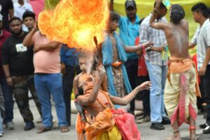 A person performs a fire - breathing act surrounded by onlookers. In the context of 2025 being the Year of Micro - Influencers, this unique performance might be a moment captured by micro - influencers to share on their platforms.