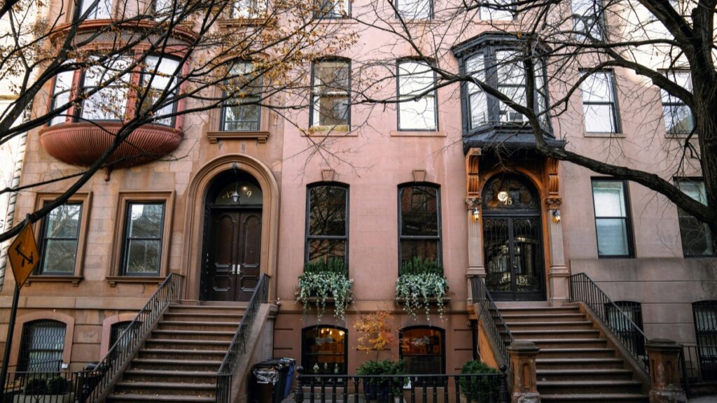 A charming row of historic brownstone buildings in the U.S., featuring ornate architectural details, elegant bay windows, and inviting entrances flanked by steps. This picturesque urban scene is associated with the 2025 Charging Standards for LinkedIn Influencer Promotions in the U.S., highlighting the aesthetic backdrop relevant to influencer marketing initiatives.
