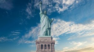 The Statue of Liberty against a backdrop of a partly - cloudy sky. This iconic symbol also relates to the 2025 Charging Standards for iMessage Influencer Promotions in China, highlighting international and promotional themes.